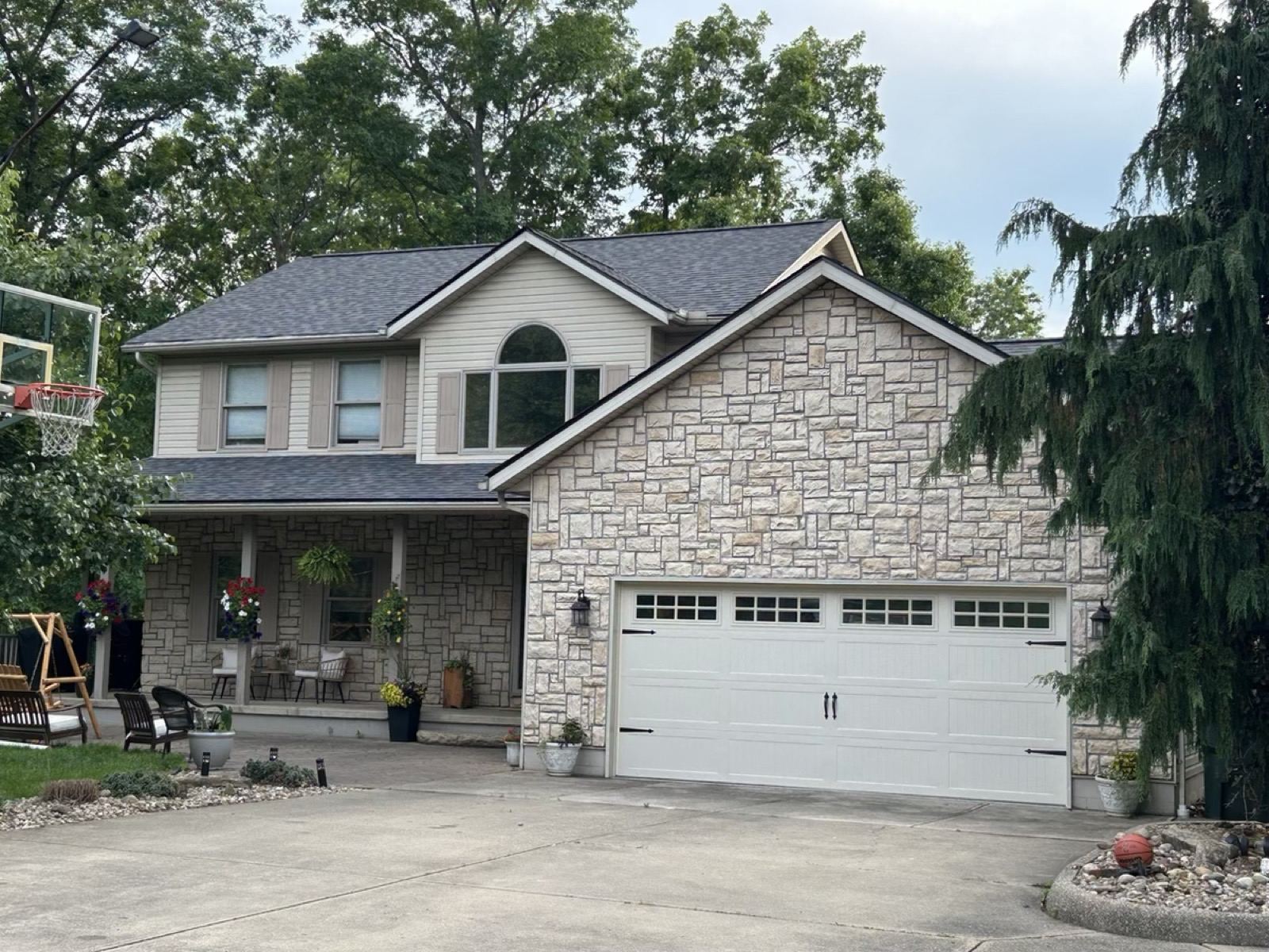 Two-story stone front home with a new roof